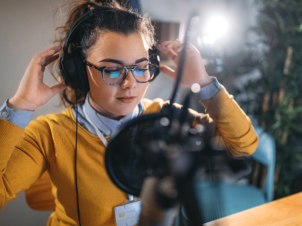 A girl records a podcast