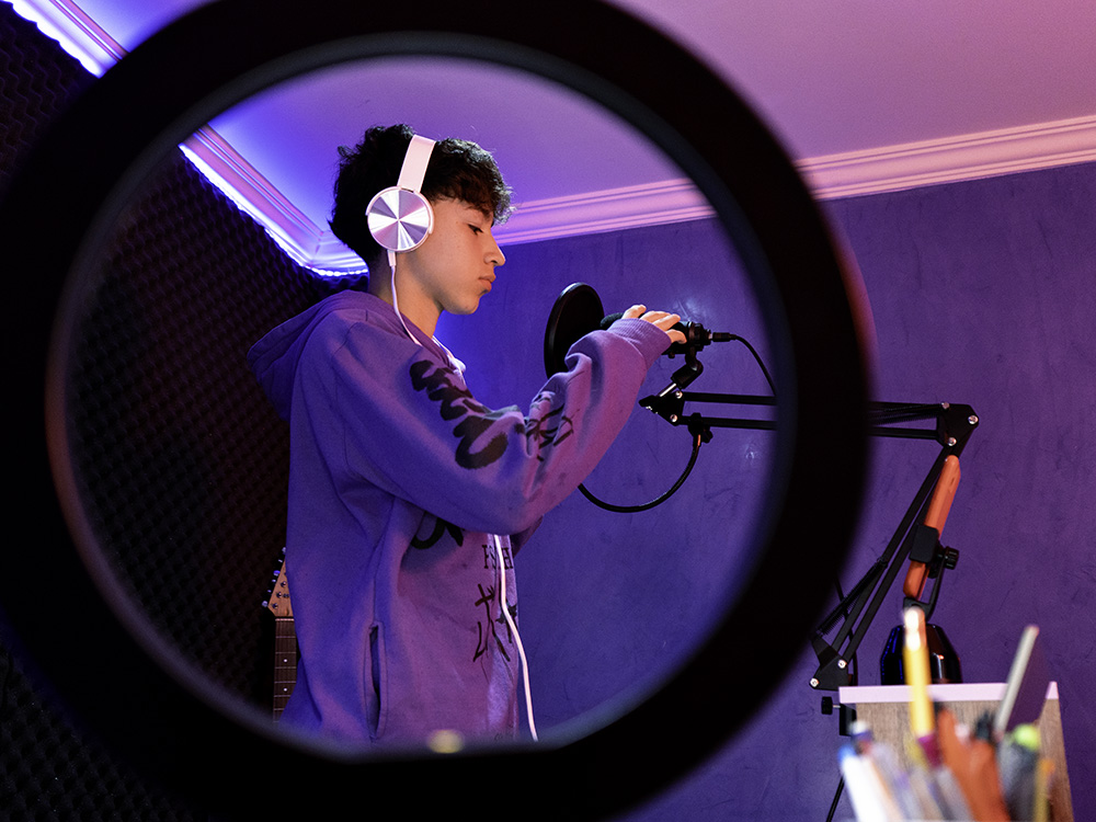 A boy records a podcast