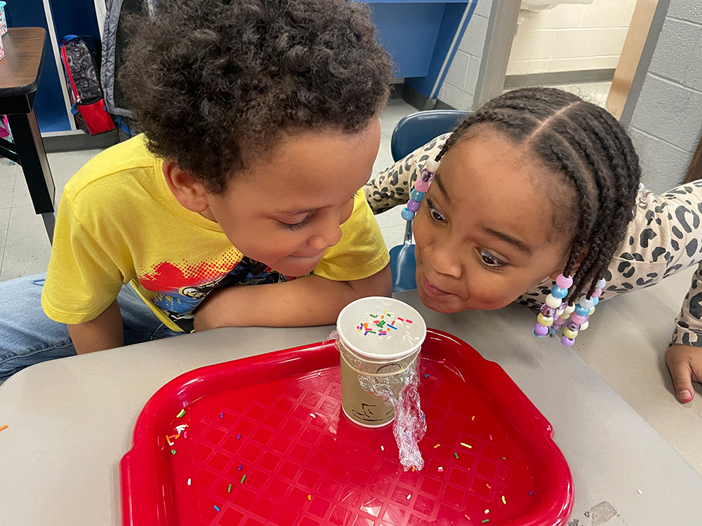 Kids looking at a science experiment