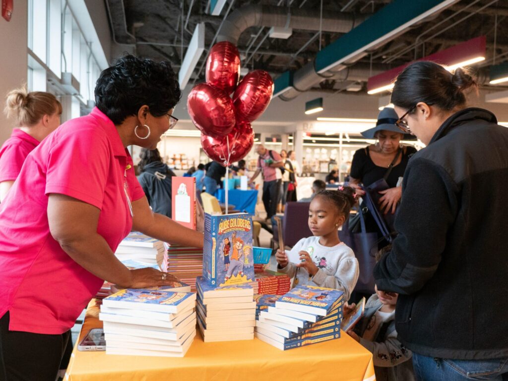 A child getting a free book at a Ready, Set, Explore event